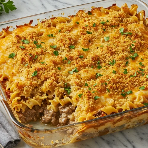 Beef Stroganoff Casserole with golden breadcrumbs and cheese topping, served in a baking dish on a marble countertop
