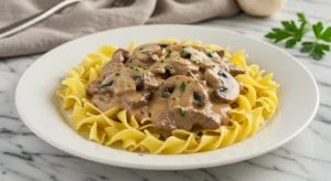 Classic Beef Stroganoff recipe Served Over Buttery Egg Noodles